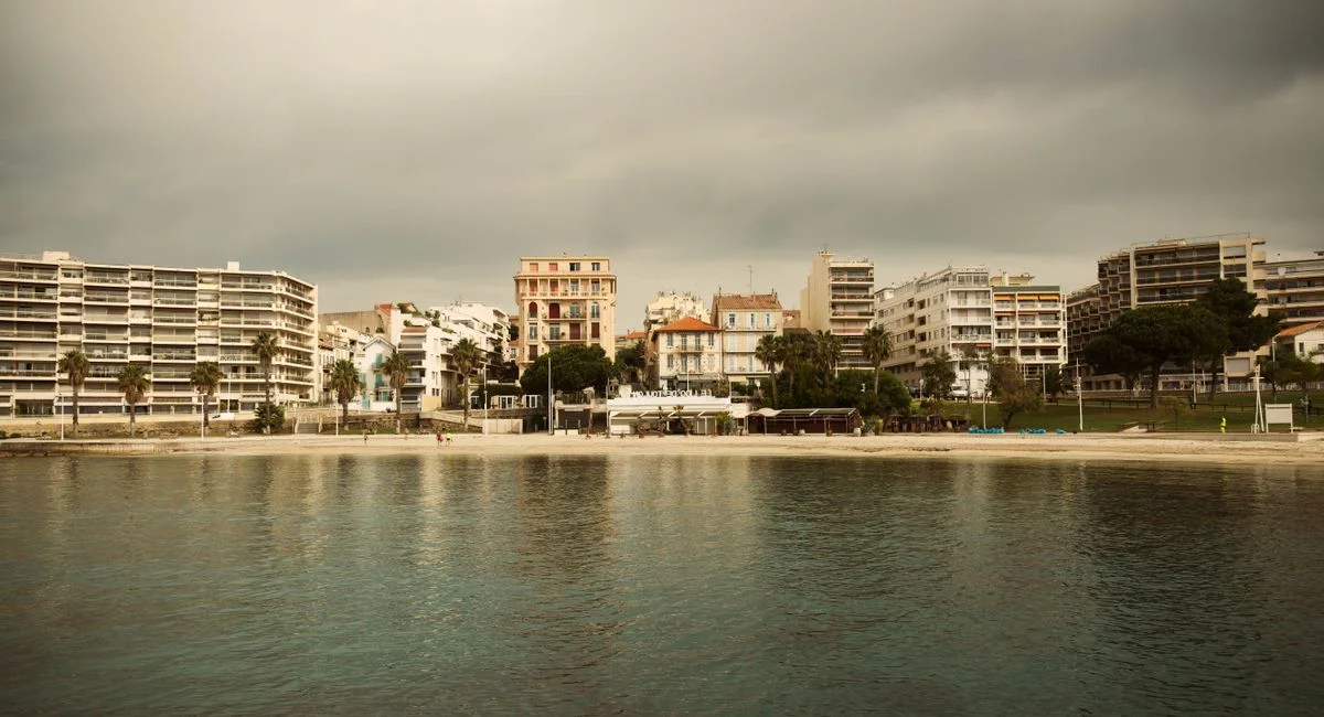 Scenic view of Toulon's beachfront with modern architecture under a cloudy sky.