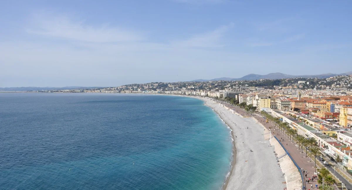 A stunning aerial view of Nice's beachfront along the French Riviera, showcasing the city's coastline.